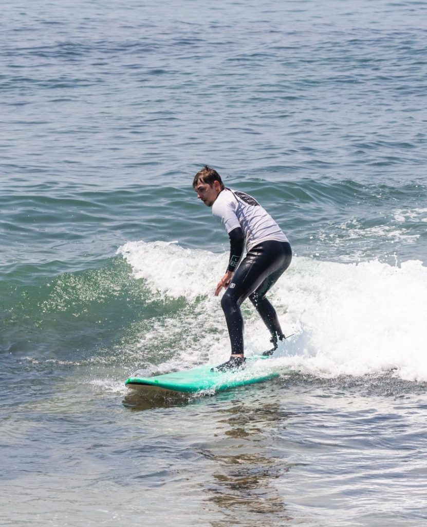 Surf coaching in Ericeira: student riding a small wave